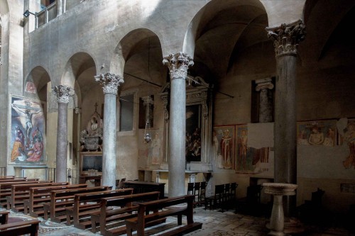 Basilica of Santi Quattro Coronati, right nave with paintings from the XIV century, in the background built-in columns from the IX century from the original church