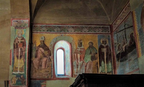 Basilica of Santi Quattro Coronati, entrance wall, frescoes from the XIV century, Bishop Rainaldus, St. Augustine and three other saints