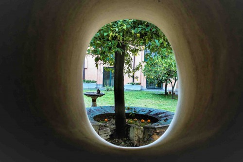 Basilica of Santa Sabina, window in the church vestibule with a view of the friary viridary and the legendary tree of St. Dominic