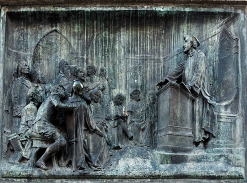 Statue of Giordano Bruno, relief depicting the philosopher teaching at Oxford