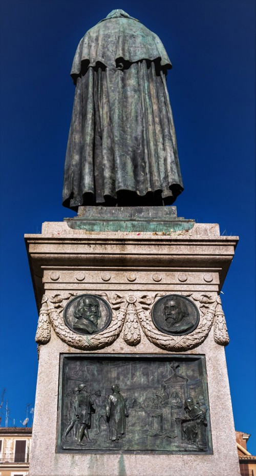 Statue of Giordano Bruno, on the plinth, scene showing the philosopher in front of the Inquisition