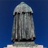 Statue of Giordano Bruno, on the plinth, scene showing the philosopher in front of the Inquisition