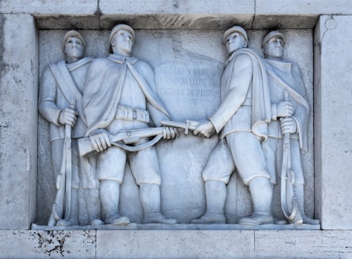 Ponte Duca d'Aosta, one of the bas-reliefs with an inscription highlighting the determination of Italian soldiers in the struggle against the  enemy