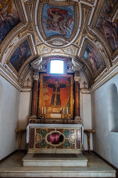 Church of Santi Cosma e Damiano, chapel with a fresco from the XIII century depicting Christ the King Crucified. Fragment of an ancient porphyry column below