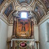 Church of Santi Cosma e Damiano, chapel with a fresco from the XIII century depicting Christ the King Crucified. Fragment of an ancient porphyry column below