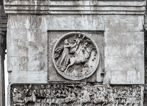 Triumphant Arch of Emperor Constantine the Great, medallion showing the God Sol Invictus, at the bottom frieze with Constantine entering Rome