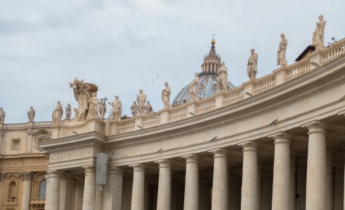 The attic crowning the colonnade designed by Gian Lorenzo Bernini