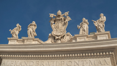 The attic of the Gian Lorenzo Bernini colonnade - statues of saints and the coat of arms of Pope Alexander VII