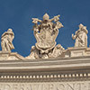 The attic of the Gian Lorenzo Bernini colonnade - statues of saints and the coat of arms of Pope Alexander VII