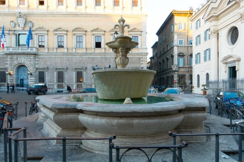 One of the two fountains in Piazza Farnese, in front of Palazzo Farnese, on the right - the facade of the Church of Santa Brigida