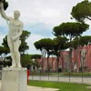 Foro Italico, statue adorning the tennis court, in the background facilities of the swimming center