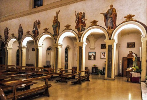 Church of Santa Prisca, view of the nave with paintings above the arcades – saints and angels with tools of the Suffering of Christ
