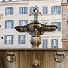 One of the two fountains in Piazza Farnese, behind the facade of the Church of Santa Brigida